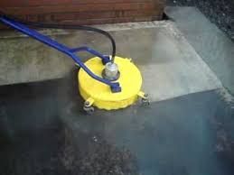 A yellow machine is being used to clean a concrete floor.