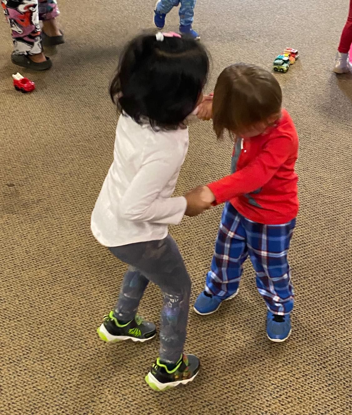 a boy and a girl are dancing together on the floor