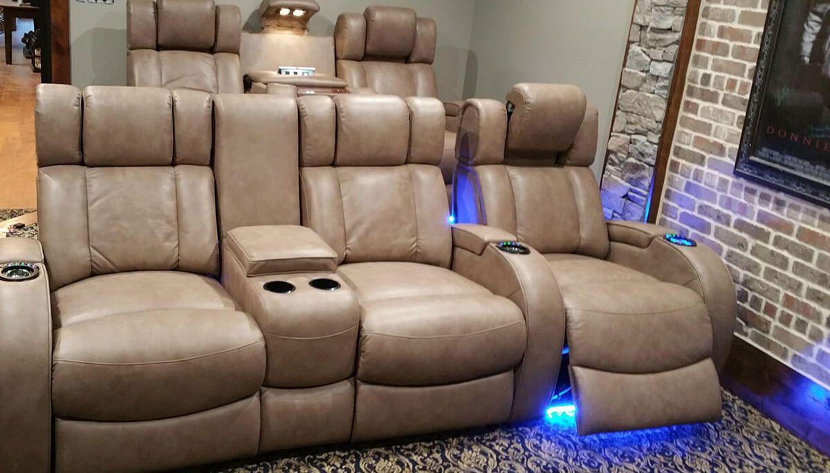 Cozy home theater with a large screen, comfortable seating, and ambient lighting.