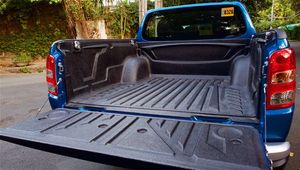 Mitsubishi Strada with a very spacious trunk, perfect for accommodating a lot of luggage, available for car rental in Palawan, Philippines.