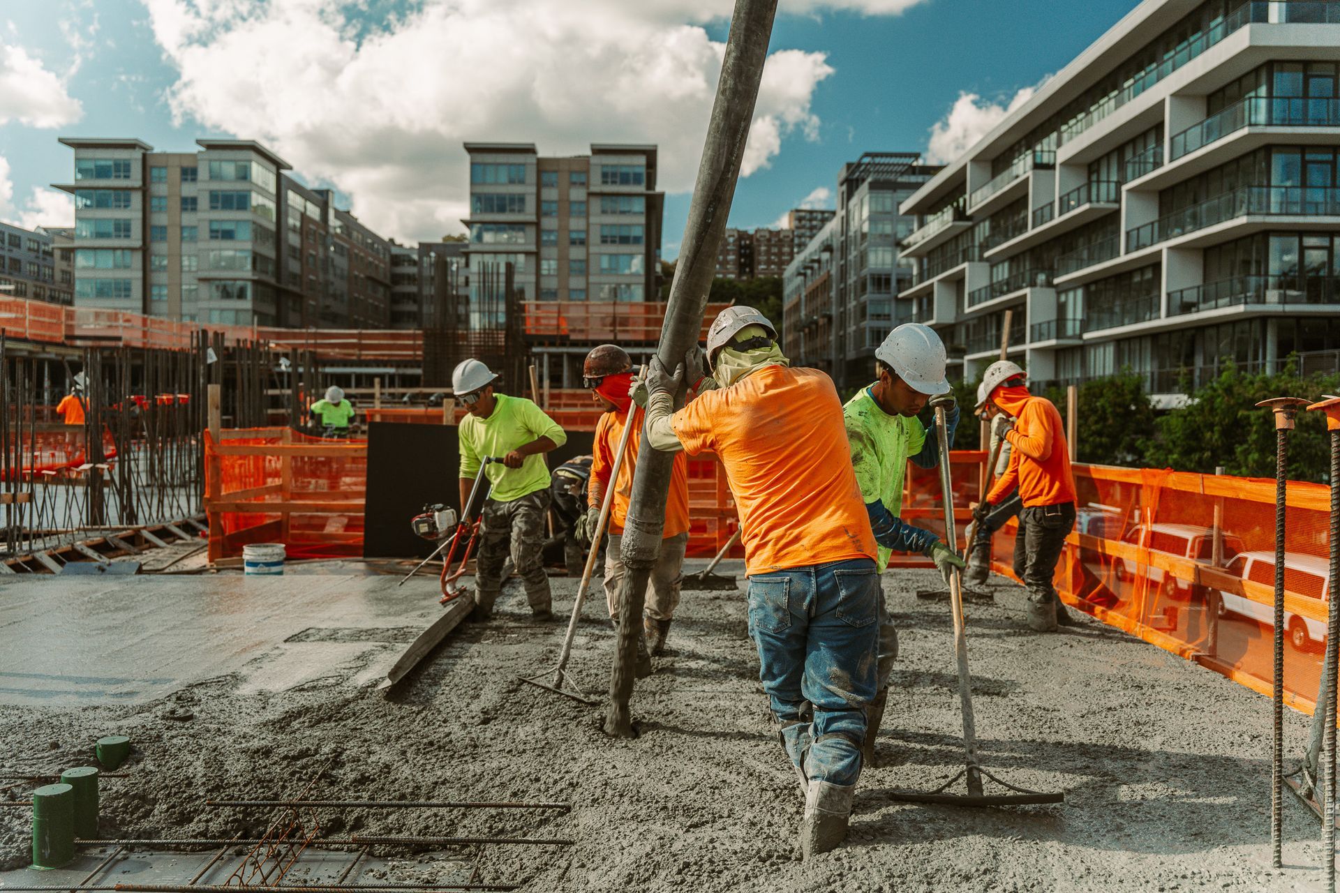 Construction workers pouring concrete at a building site. 