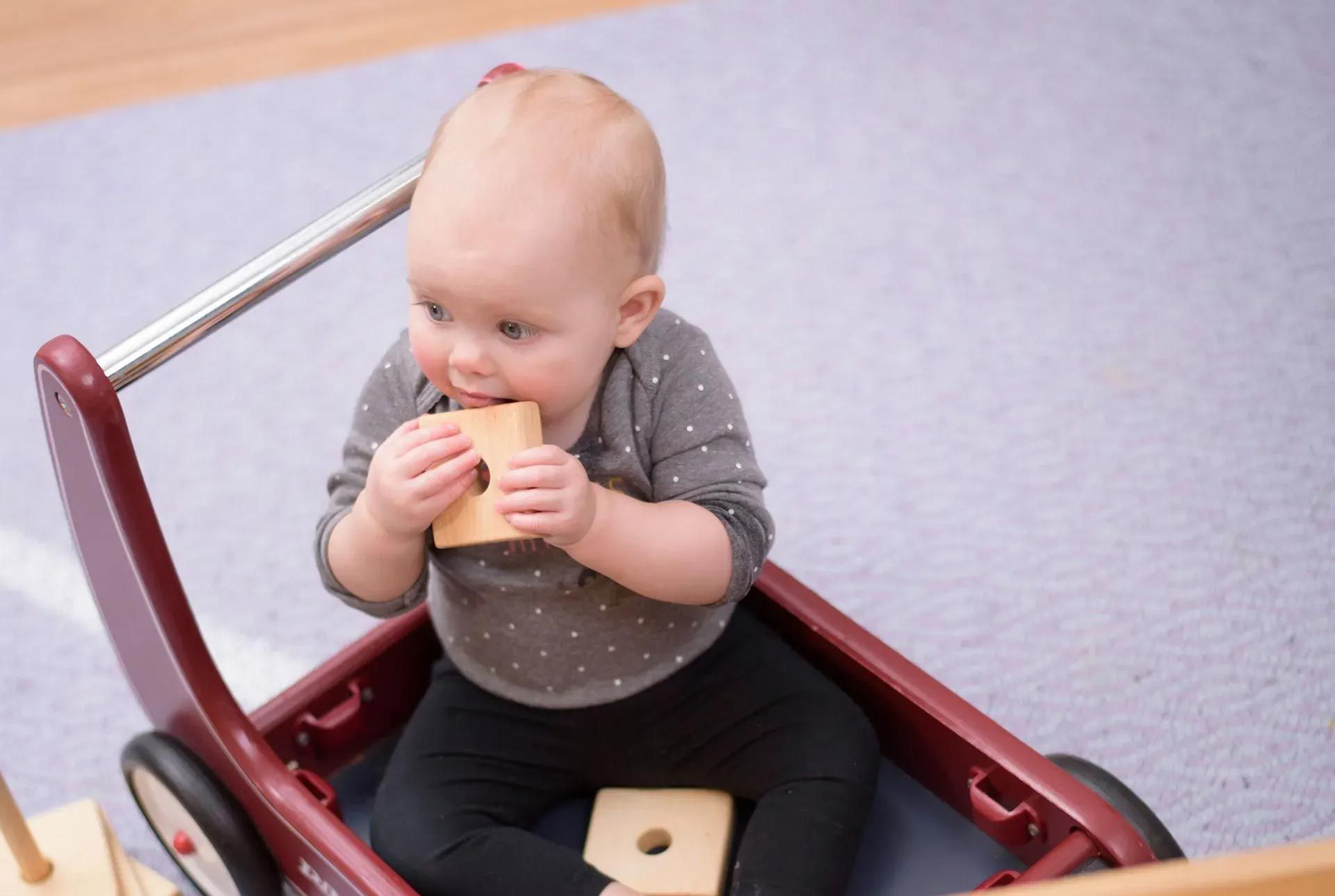 A Montessori child manipulating wood blocks.