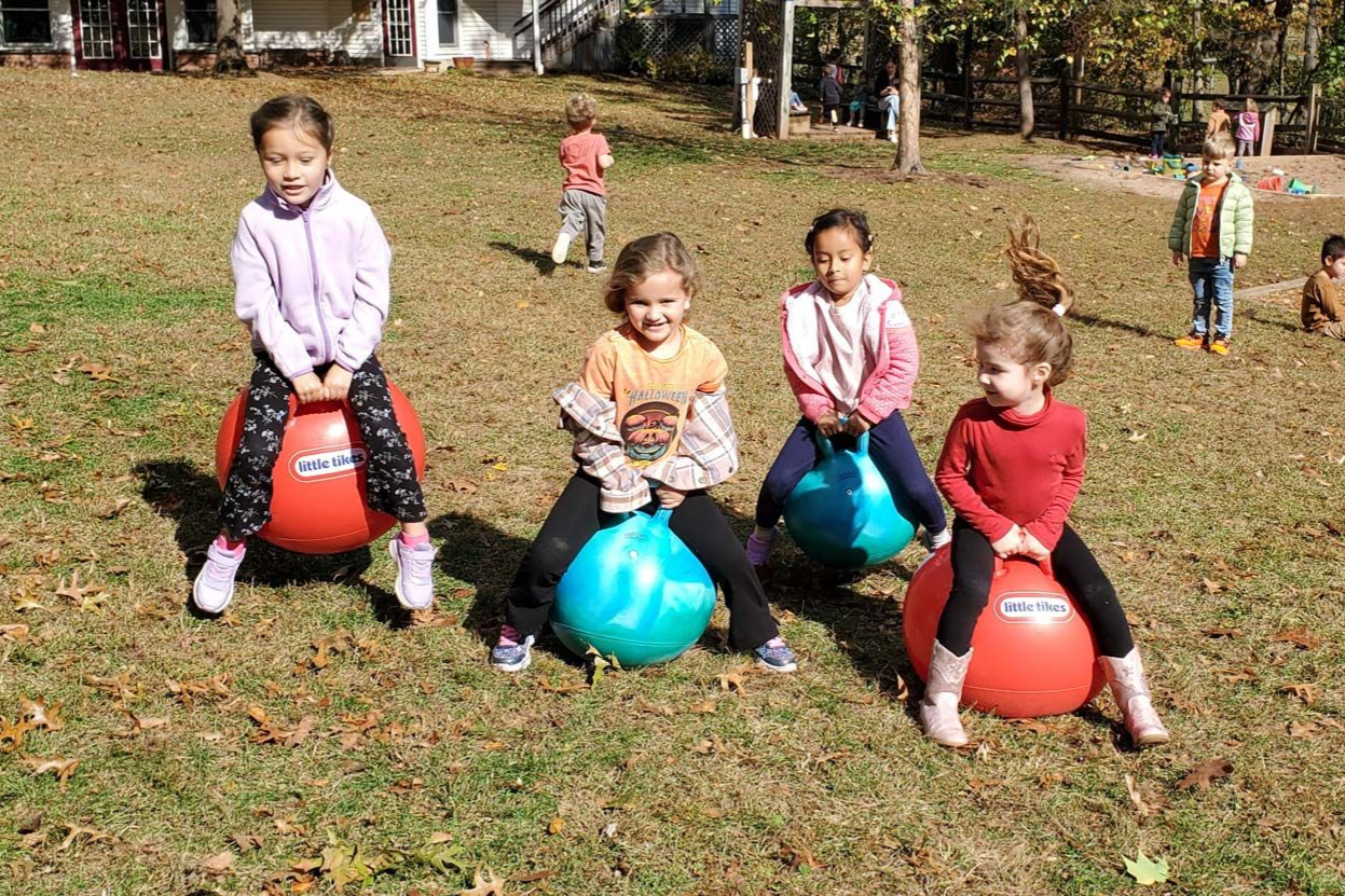 Two young Montessori students are working with pink tower.