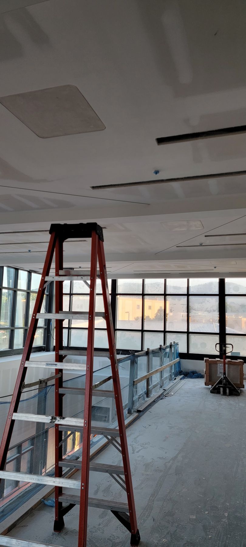 Wooden ceiling under construction with plumbing pipes visible.