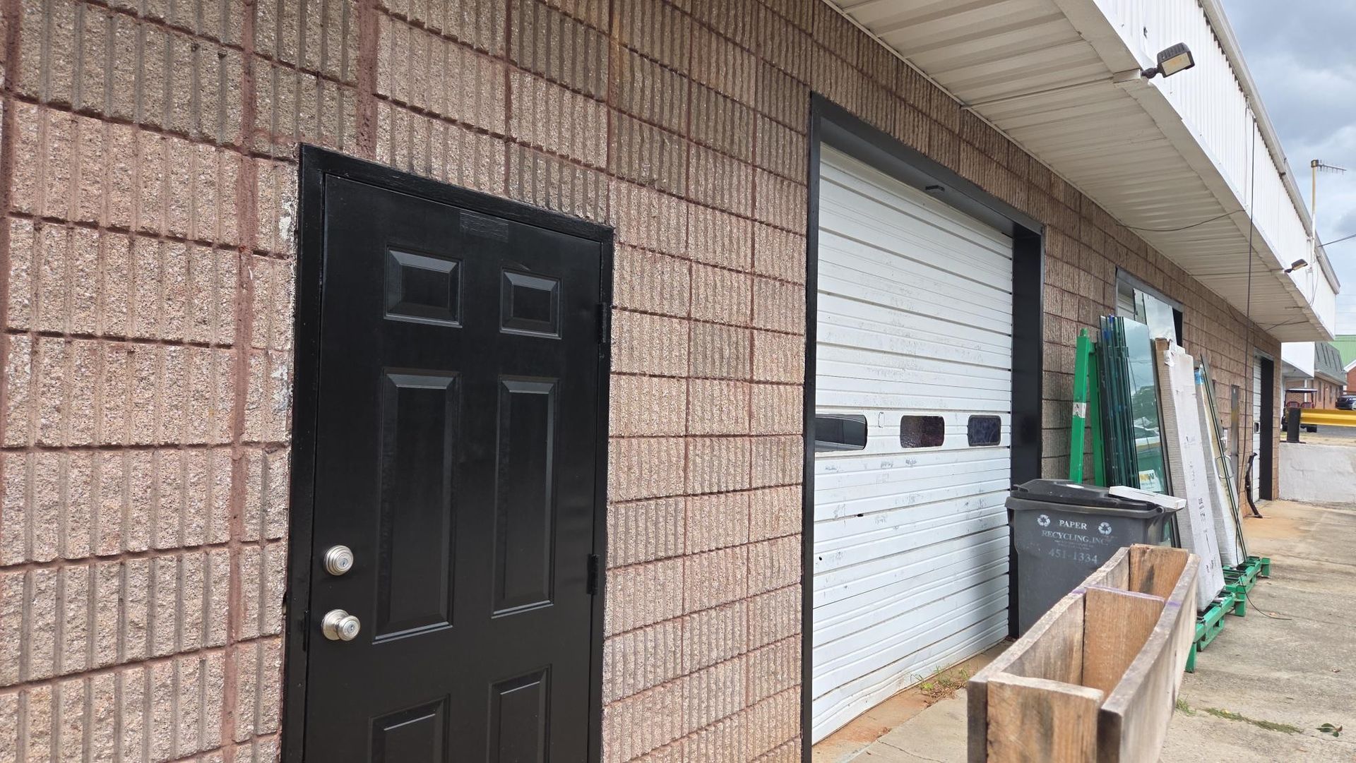 Electrician in safety gear working on electrical panel.
