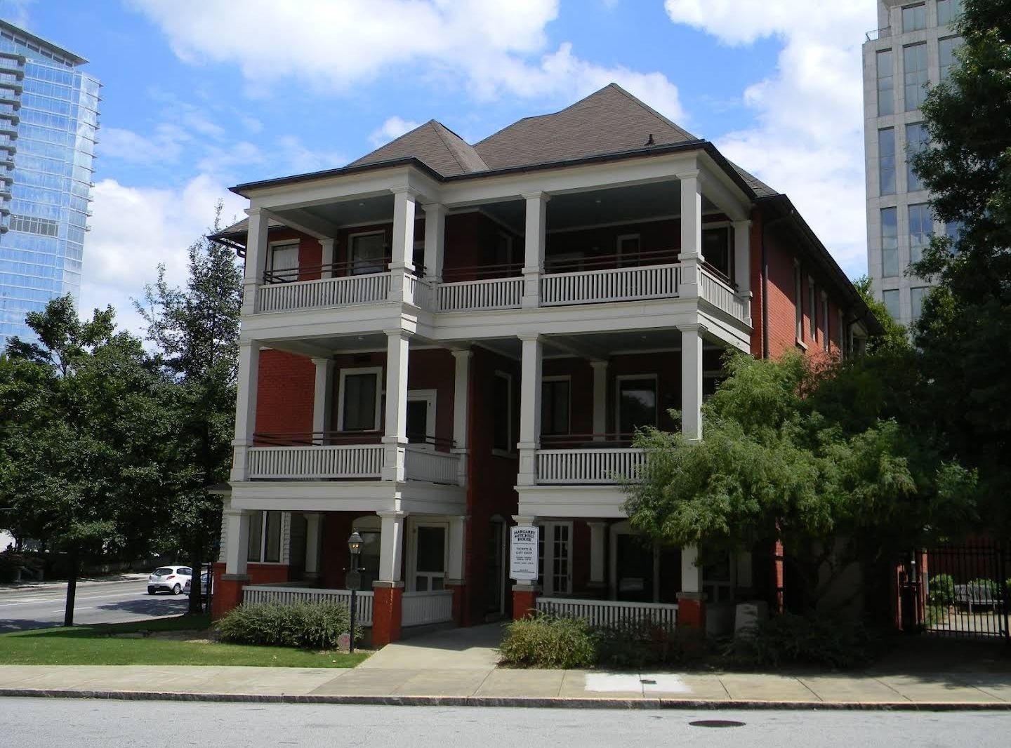 Man in mask examines crawl space with a flashlight.