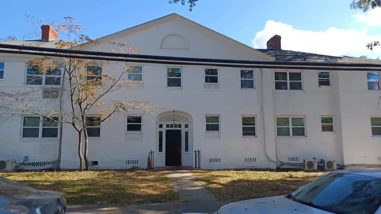 Wooden ceiling under construction with plumbing pipes visible.