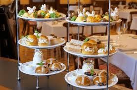 Tiered trays of assorted pastries and desserts in a warmly lit banquet setting