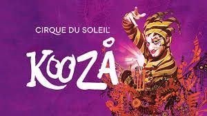 Cirque du Soleil KOOZA poster: Jester in yellow and brown costume on purple background.