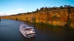 An aerial view of a boat floating on top of a river.