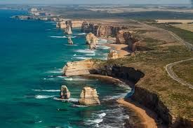 Coastal cliffs and sea stacks along the Great Ocean Road, Australia. Turquoise water, brown cliffs, sunny day.