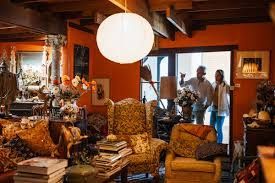 A living room filled with furniture and a man and woman standing in the doorway.