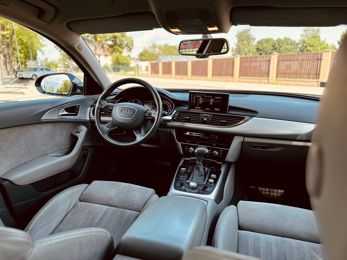 Automašīnas salons ar stūri un atpakaļskata spoguli.