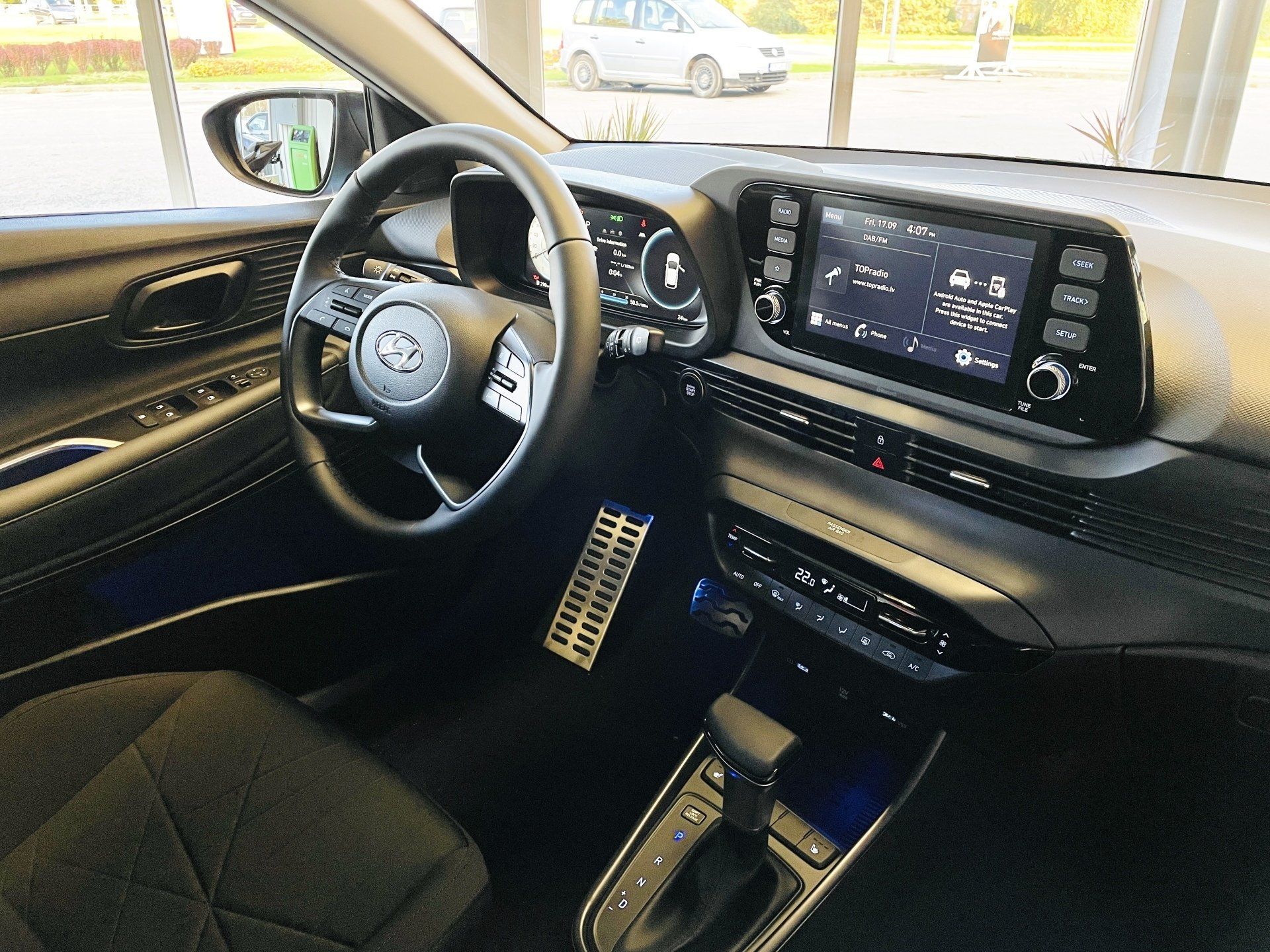 Automašīnas salons ar stūri un instrumentu paneli.