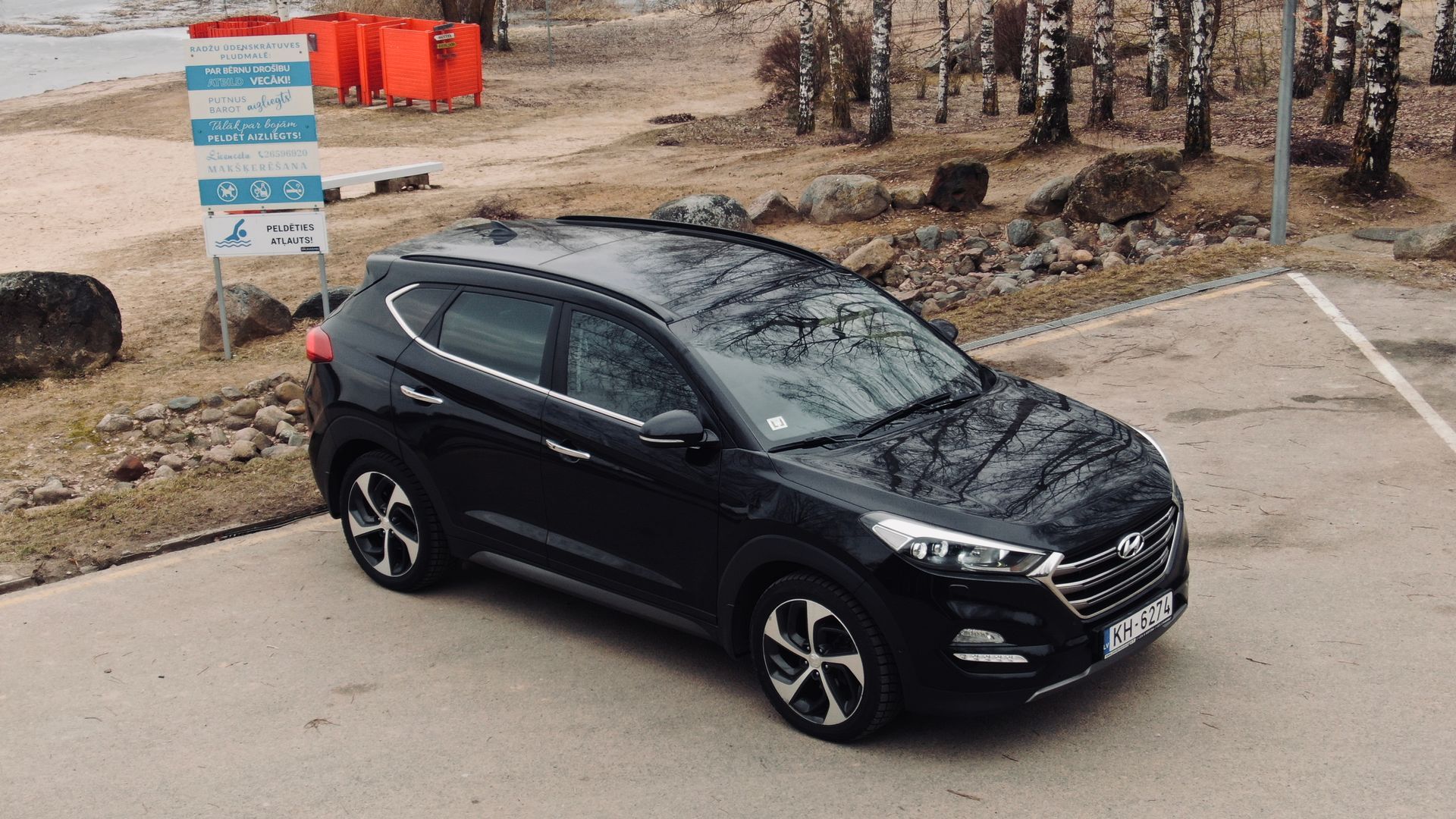 Autostāvvietā stāv melns apvidus.