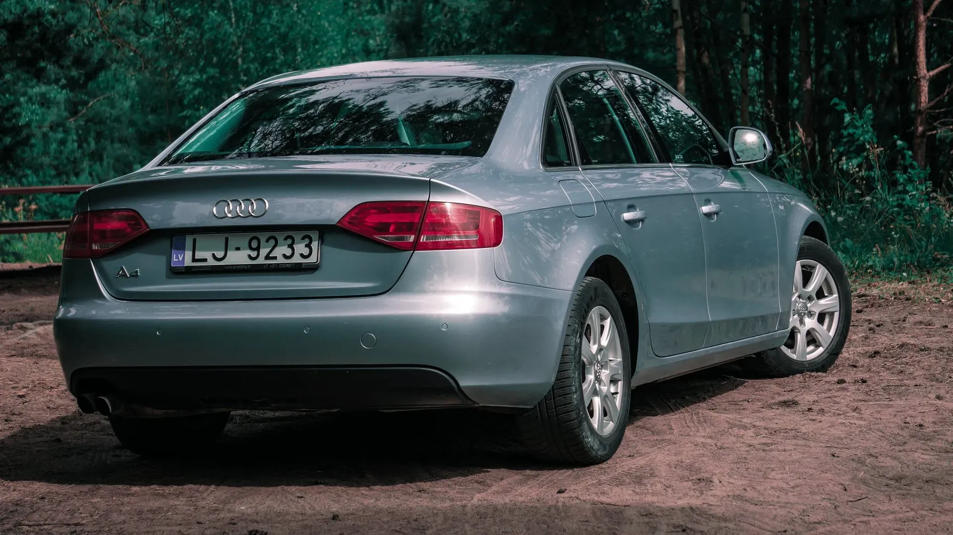 Sudrabains audi a4 ir novietots mežā zemes gabalā.