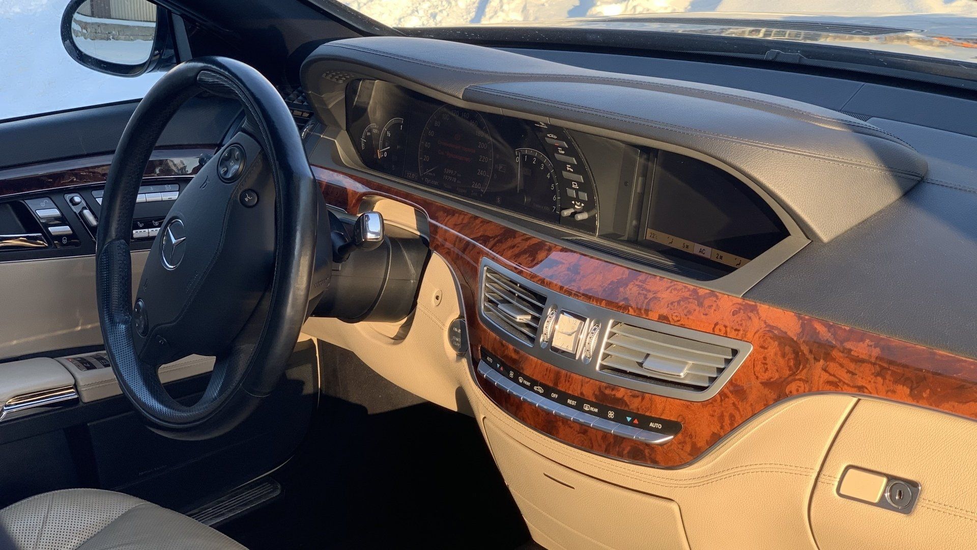 Automašīnas salons ar koka paneļu un stūri.