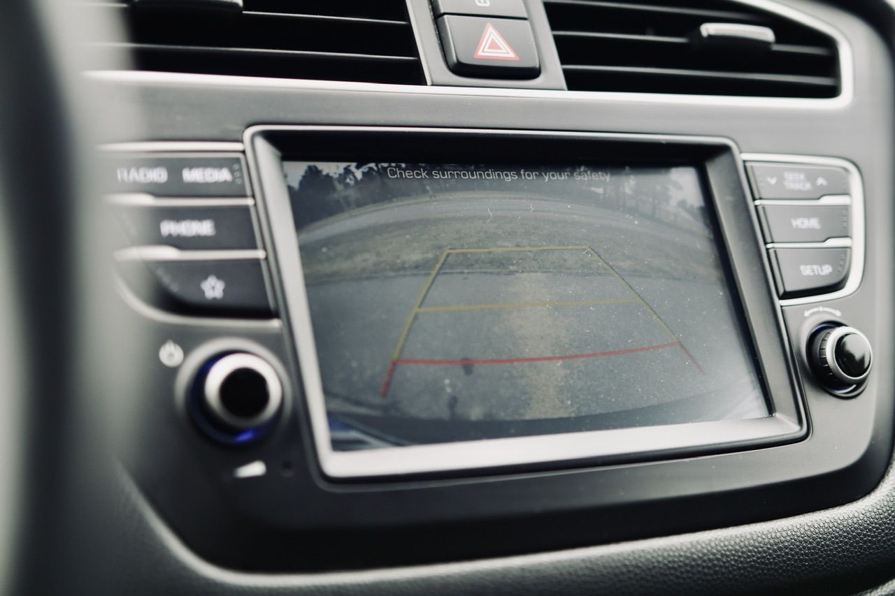 Uz automašīnas paneļa tiek parādīta atpakaļskata kamera.