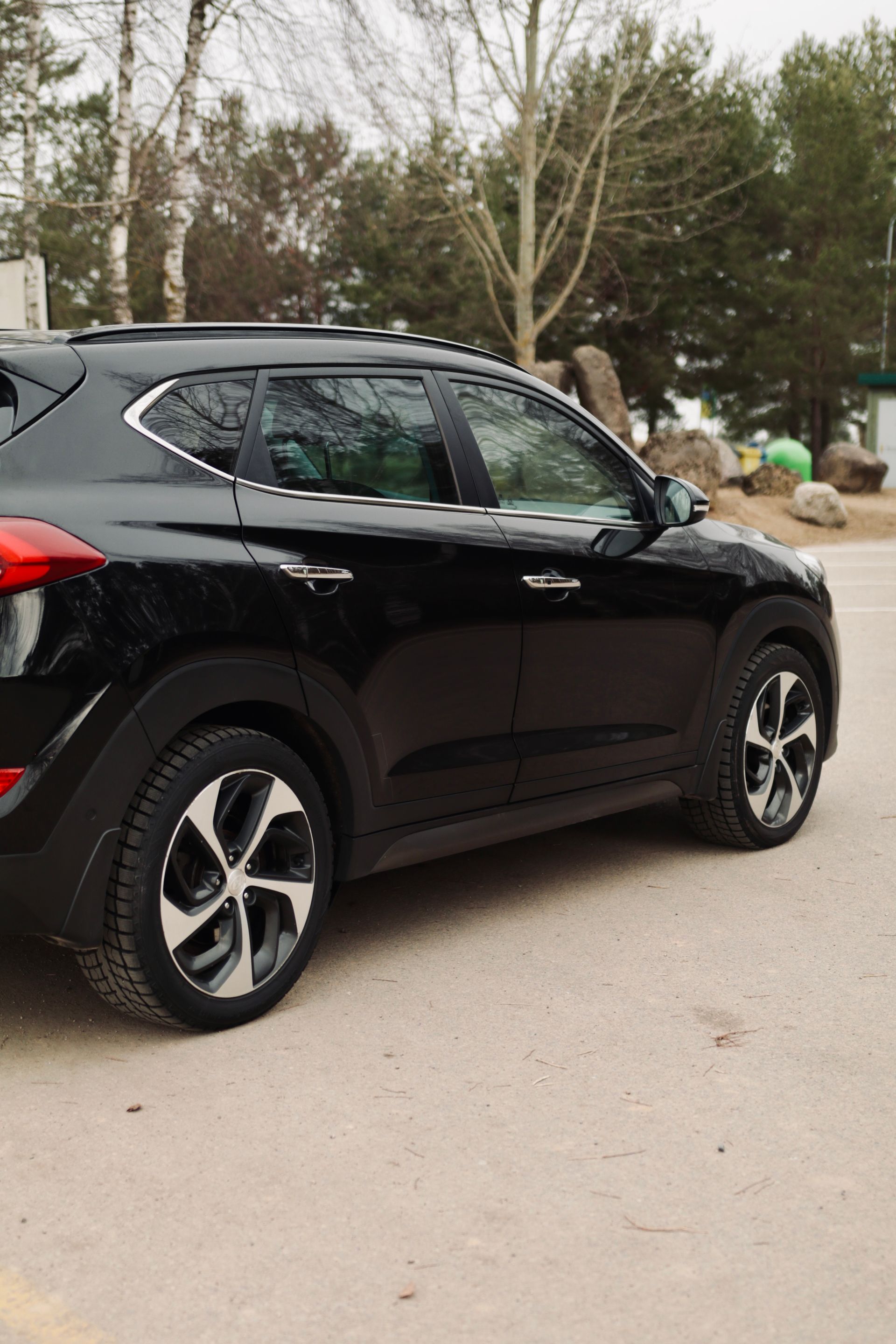 Autostāvvietā stāv melns apvidus.