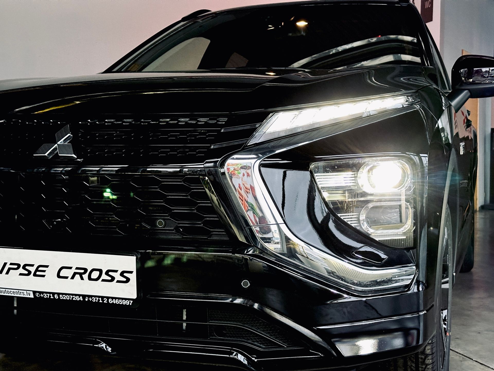 Melns mitsubishi aptumsuma krusts ir novietots garāžā.