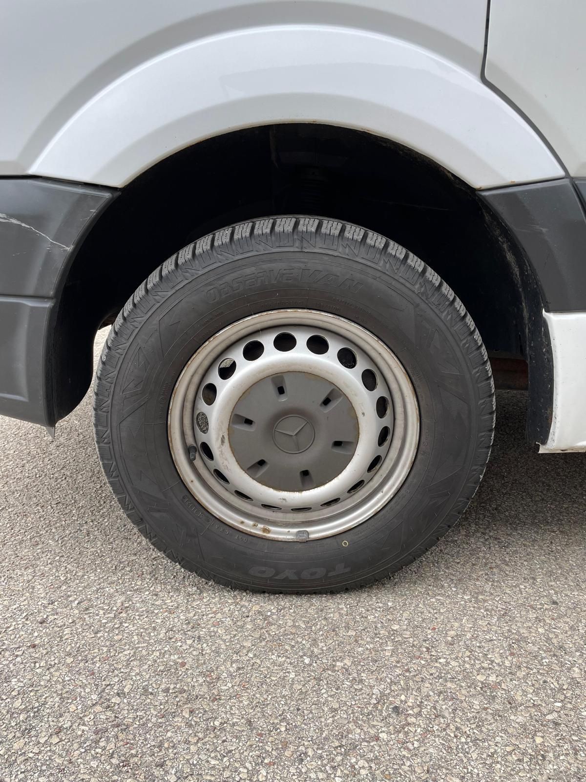 Tuvplāns no automašīnas riteņa uz grants ceļa.