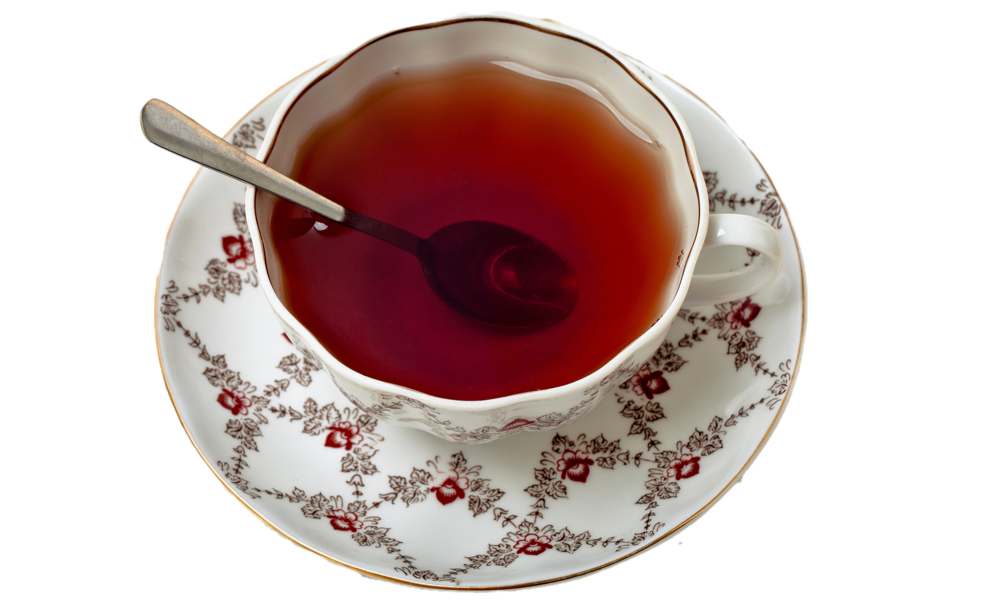 Tazza da tè con cucchiaino, su piattino con motivo floreale.