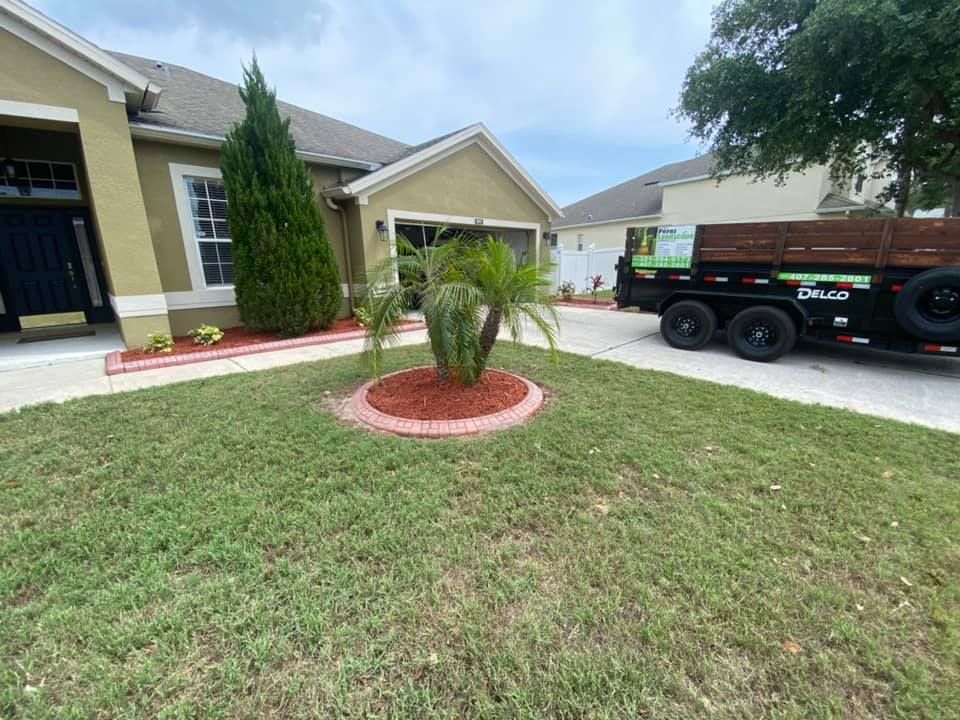 A dumpster is parked in front of a house.