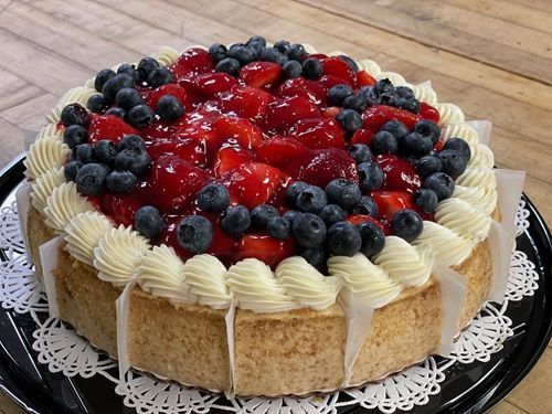 A close up of a plate of food with strawberries and blueberries on a table.