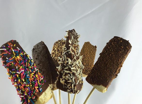 A bunch of chocolate covered bananas with sprinkles on them