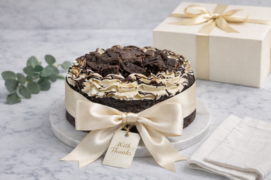 A white plate topped with a cake , strawberries , limes and chocolate chips.