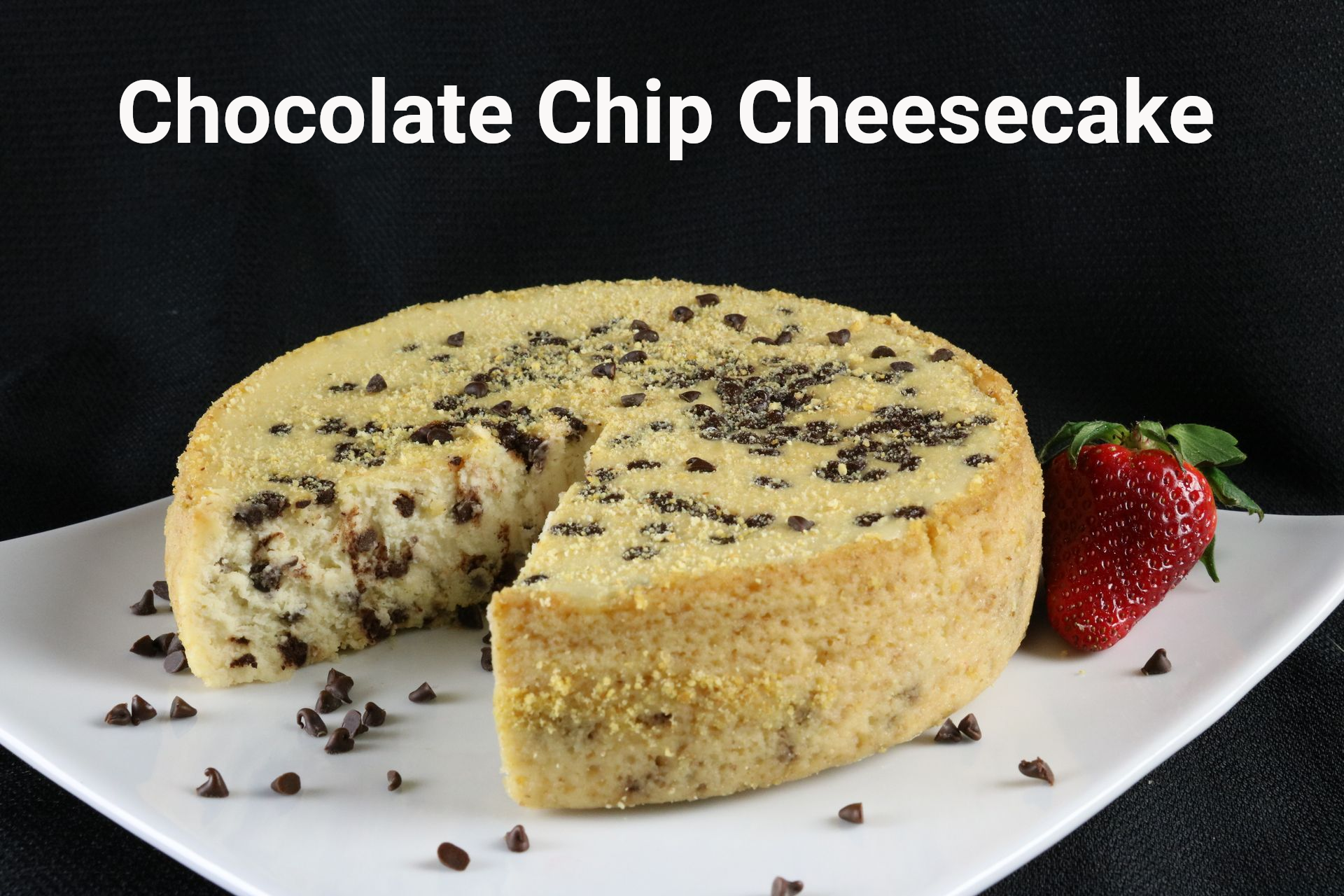 A cake with chocolate chips and a strawberry on a white plate