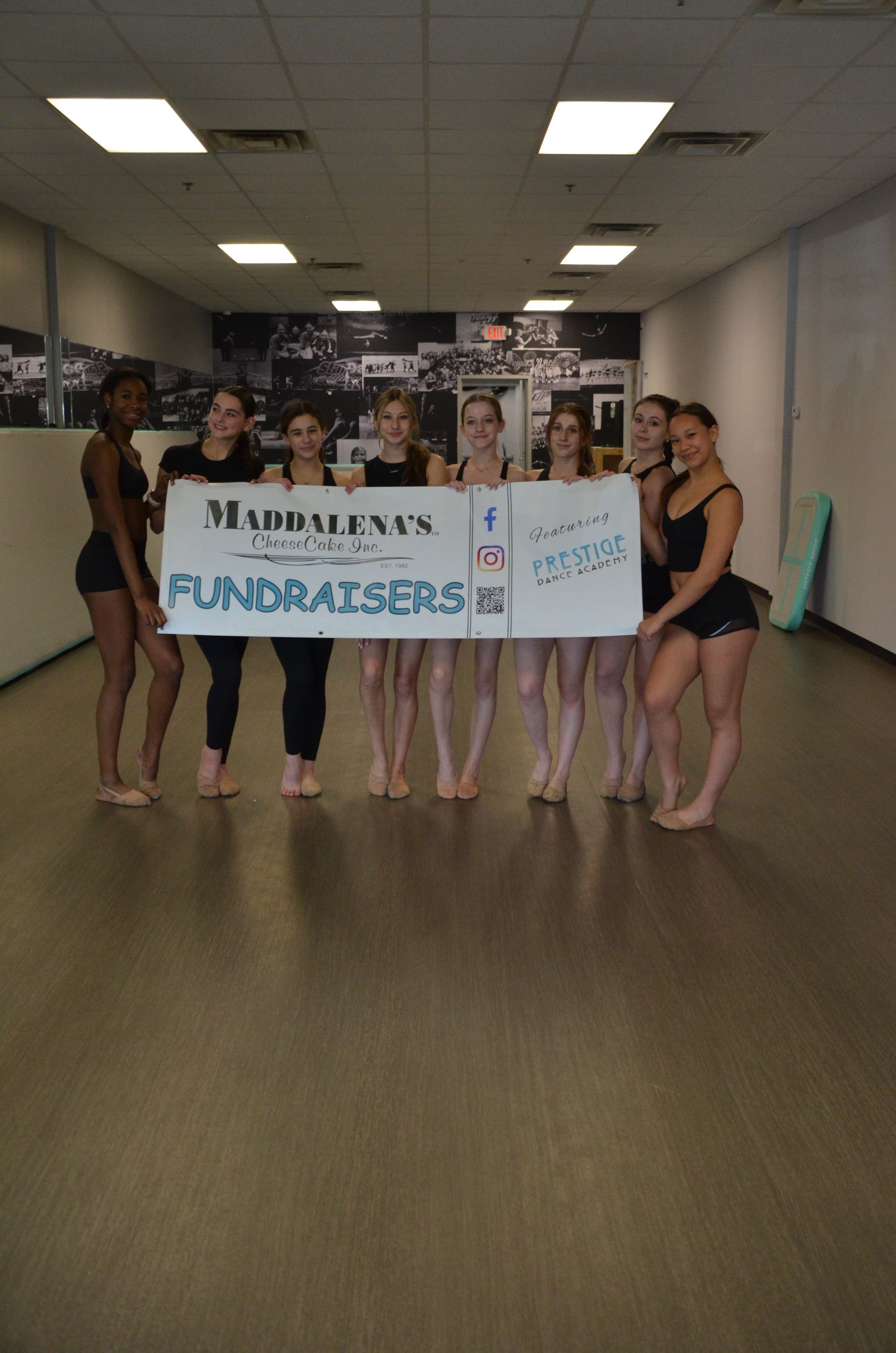 Dancers holding a banner that says 