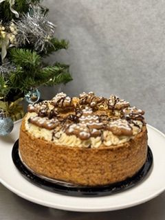 Pumpkin CheeseCake with Madd Gingerbread cookie, a drizzle of  caramel  and cream cheese icing border.