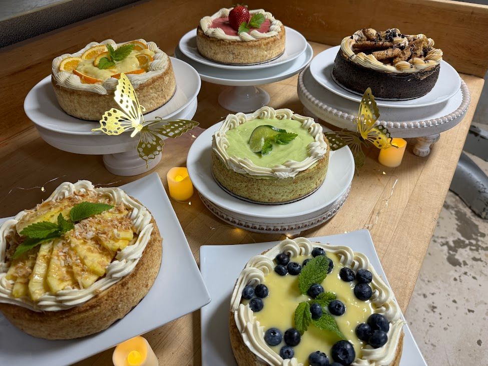 A table topped with a variety of desserts and candles.