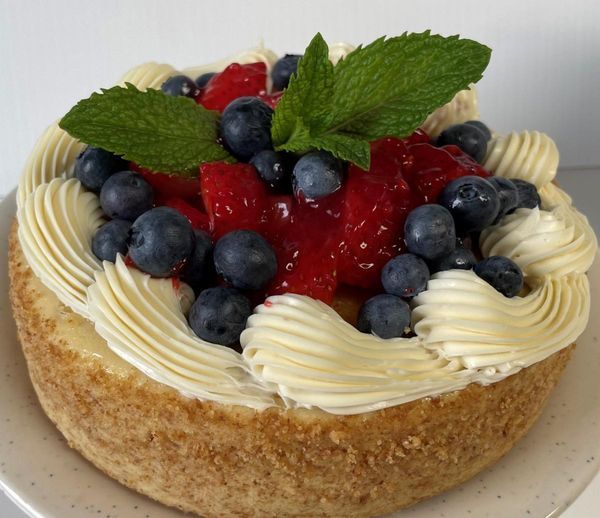 A cheesecake with strawberries and blueberries on top