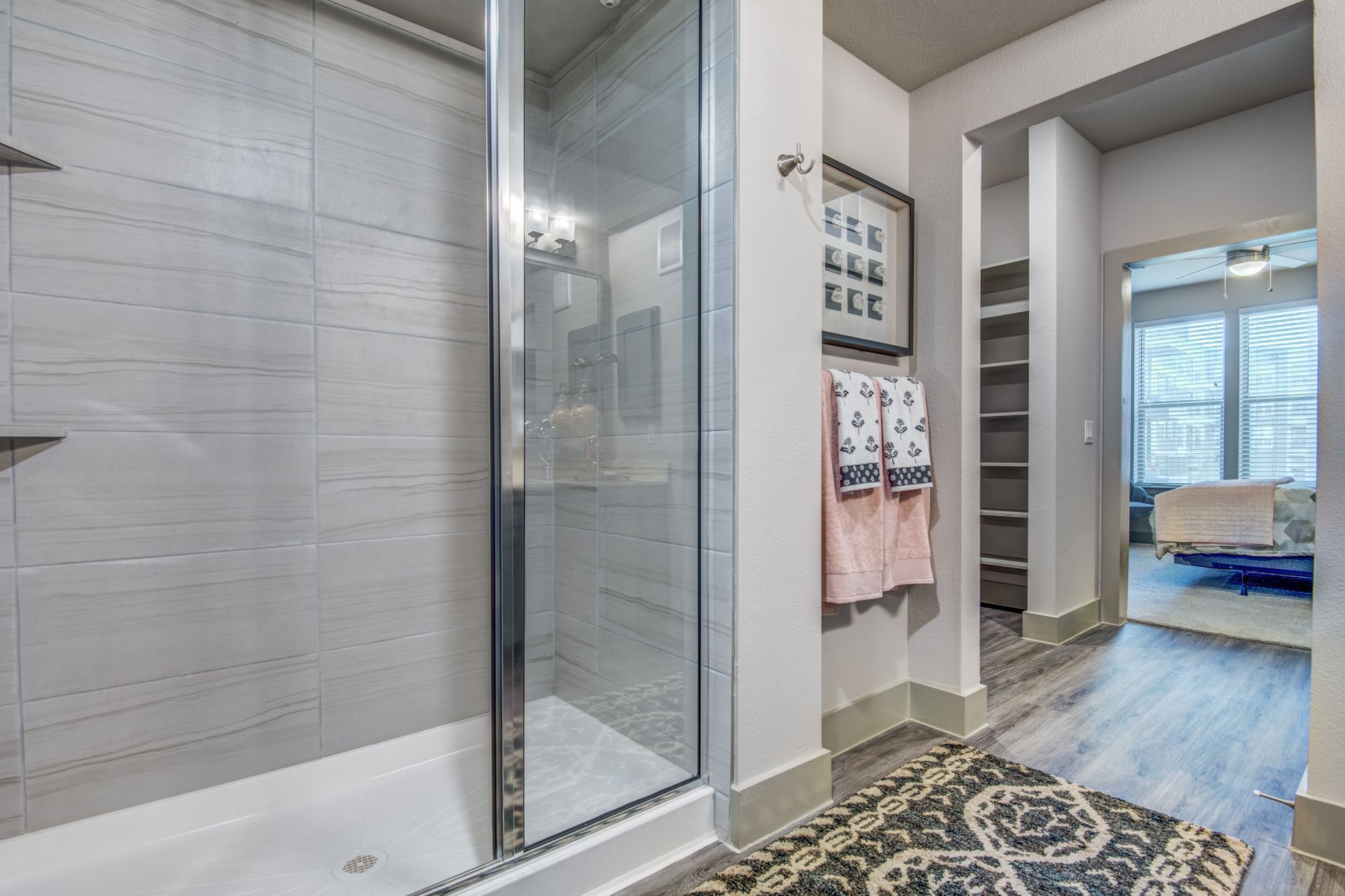Modern bathroom with a walk-in shower and a rug at Two99 Monroe offers apartments for rent in Roanoke, TX.