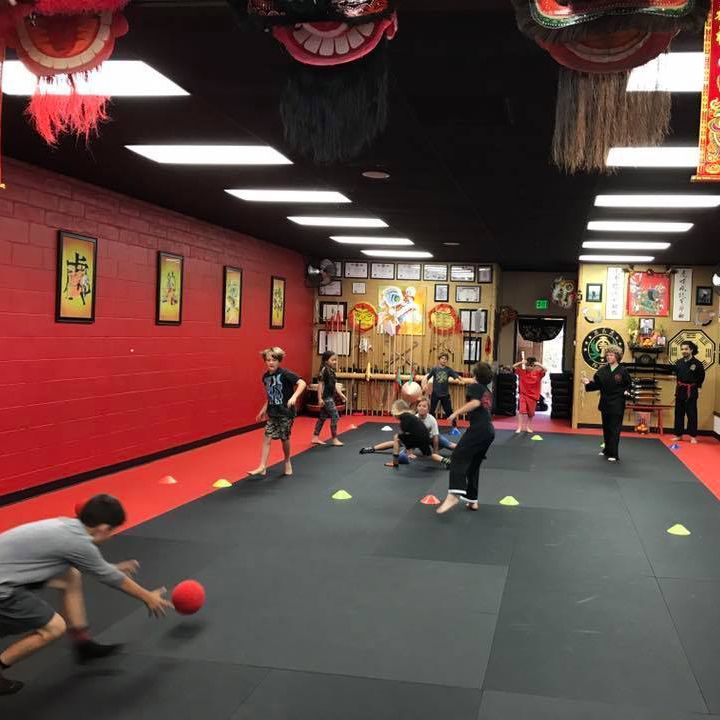 A group of kids are playing with a ball in a gym