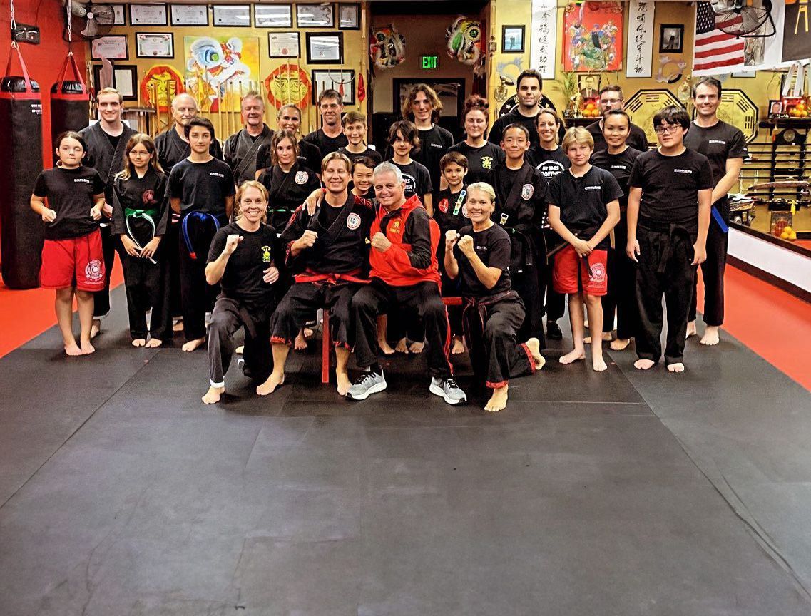 A group of people posing for a picture in a gym