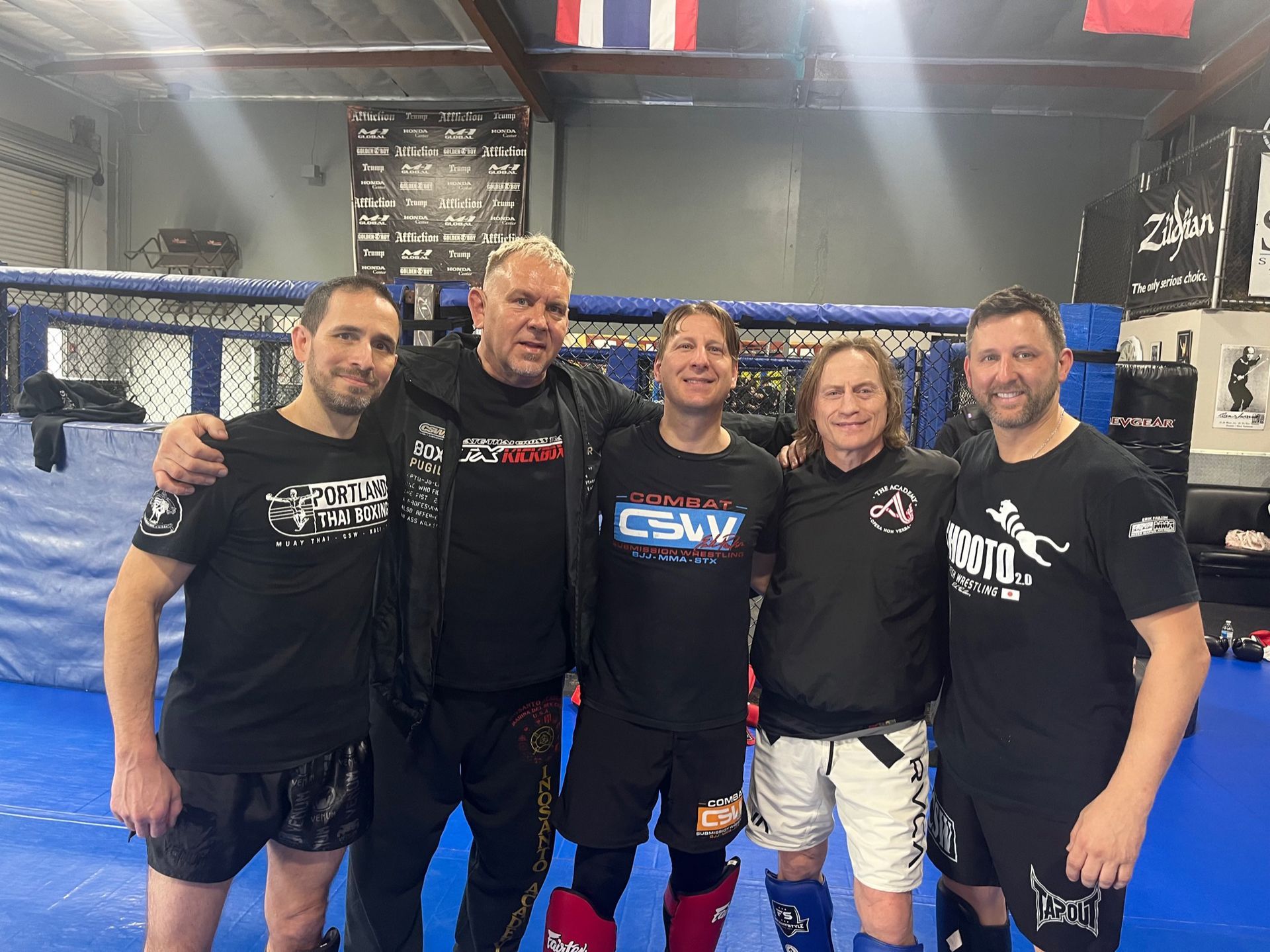 A group of men are posing for a picture in a gym.
