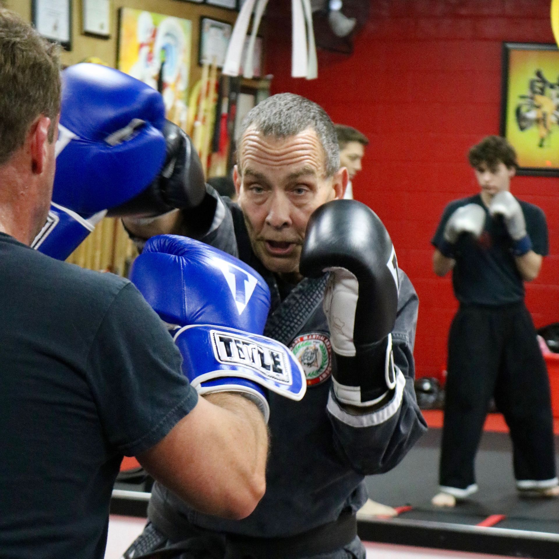 A man wearing a pair of title boxing gloves