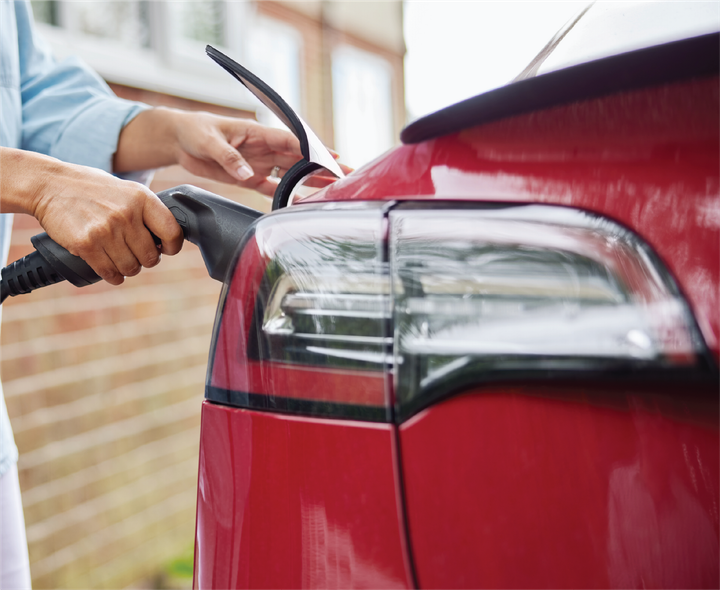 A person is charging an electric car with a charger.