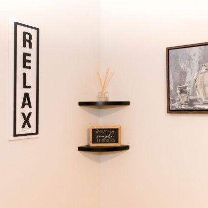 There is a picture on the wall and a sign on the wall that says `` relax ''.