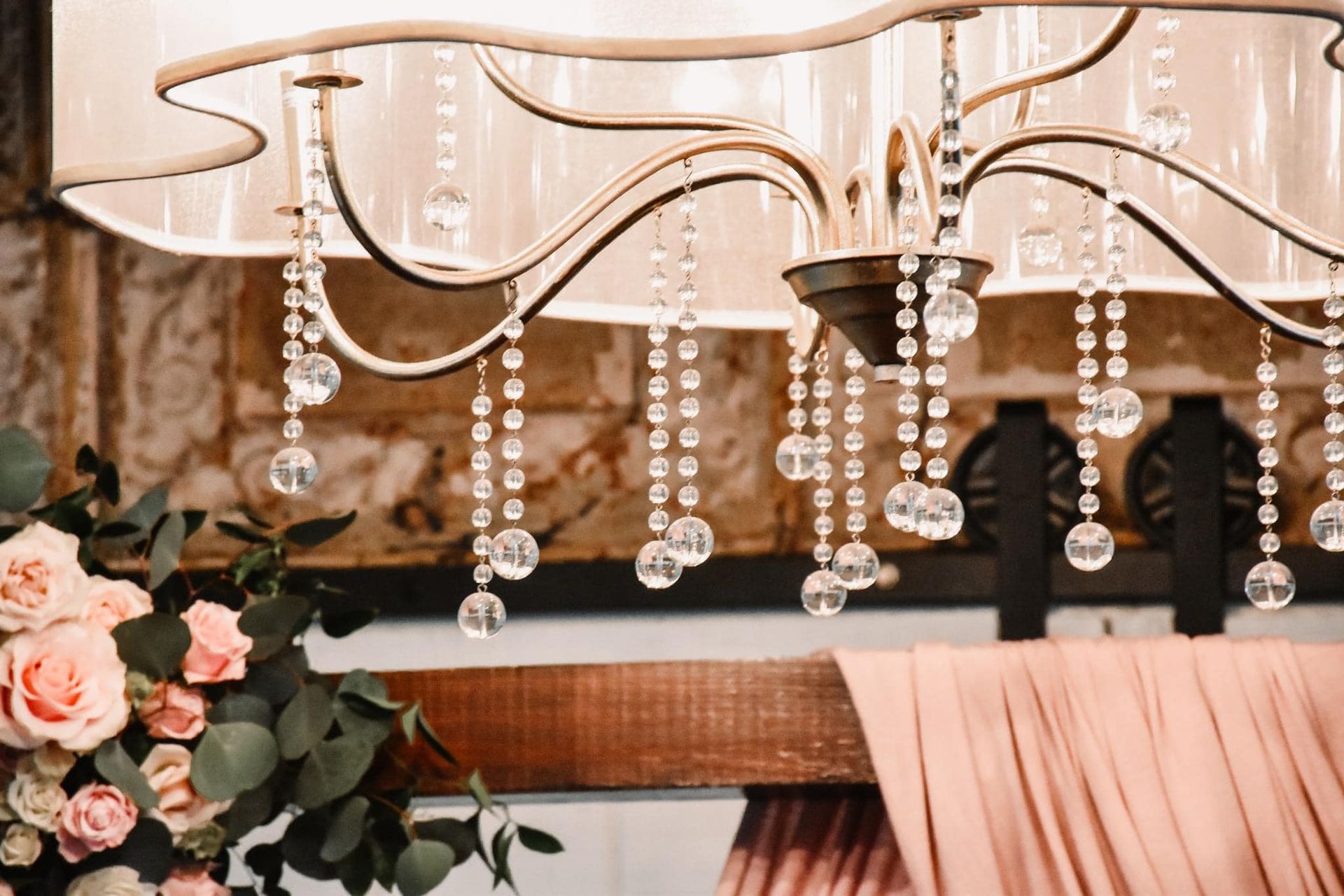 A close up of a chandelier with crystals hanging from it.