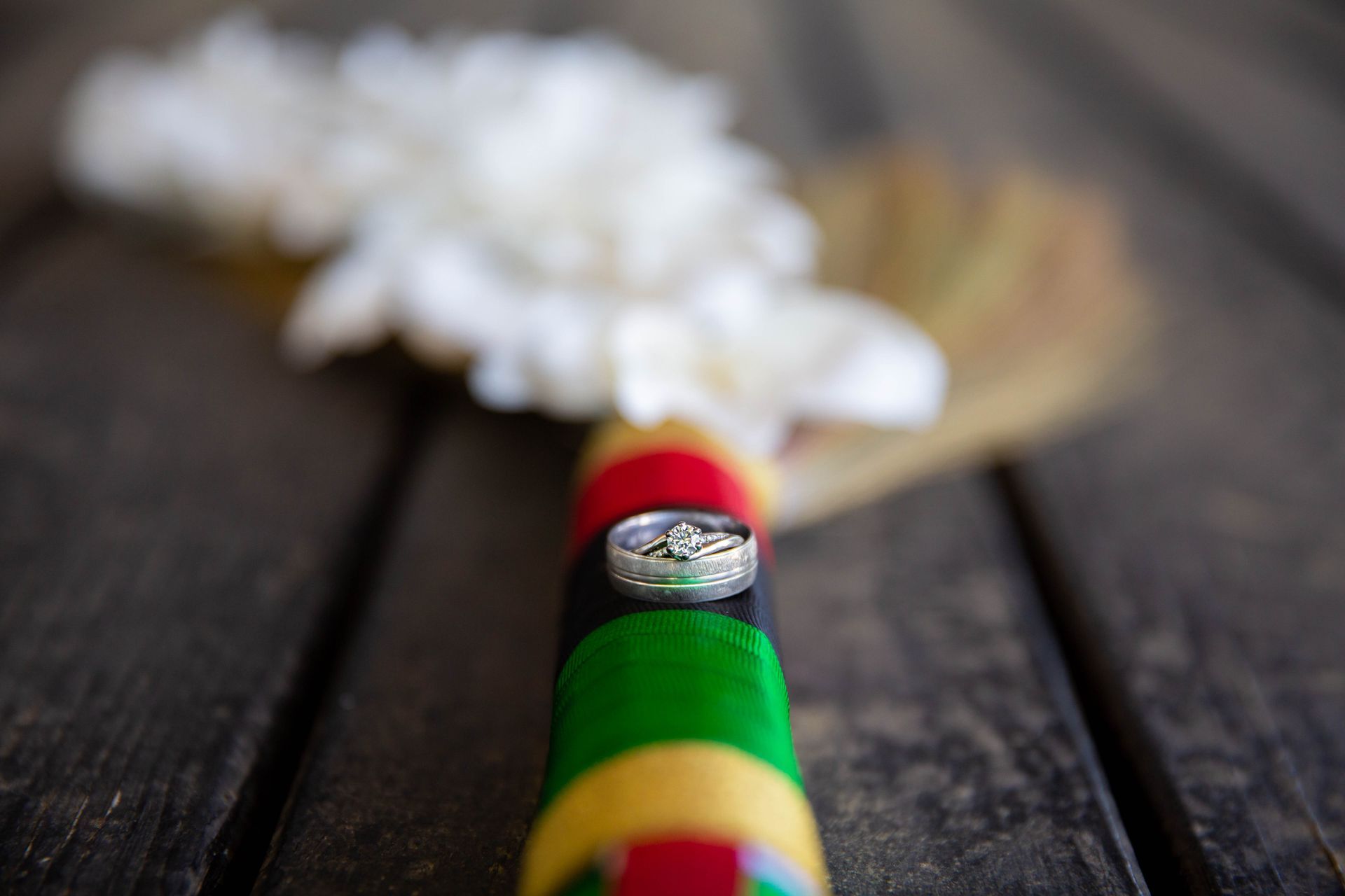 A close up of a wedding ring on a colorful stick
