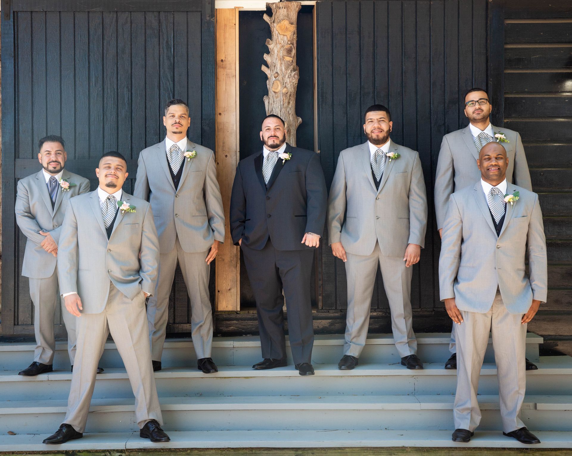 A group of men in suits and ties are posing for a picture.