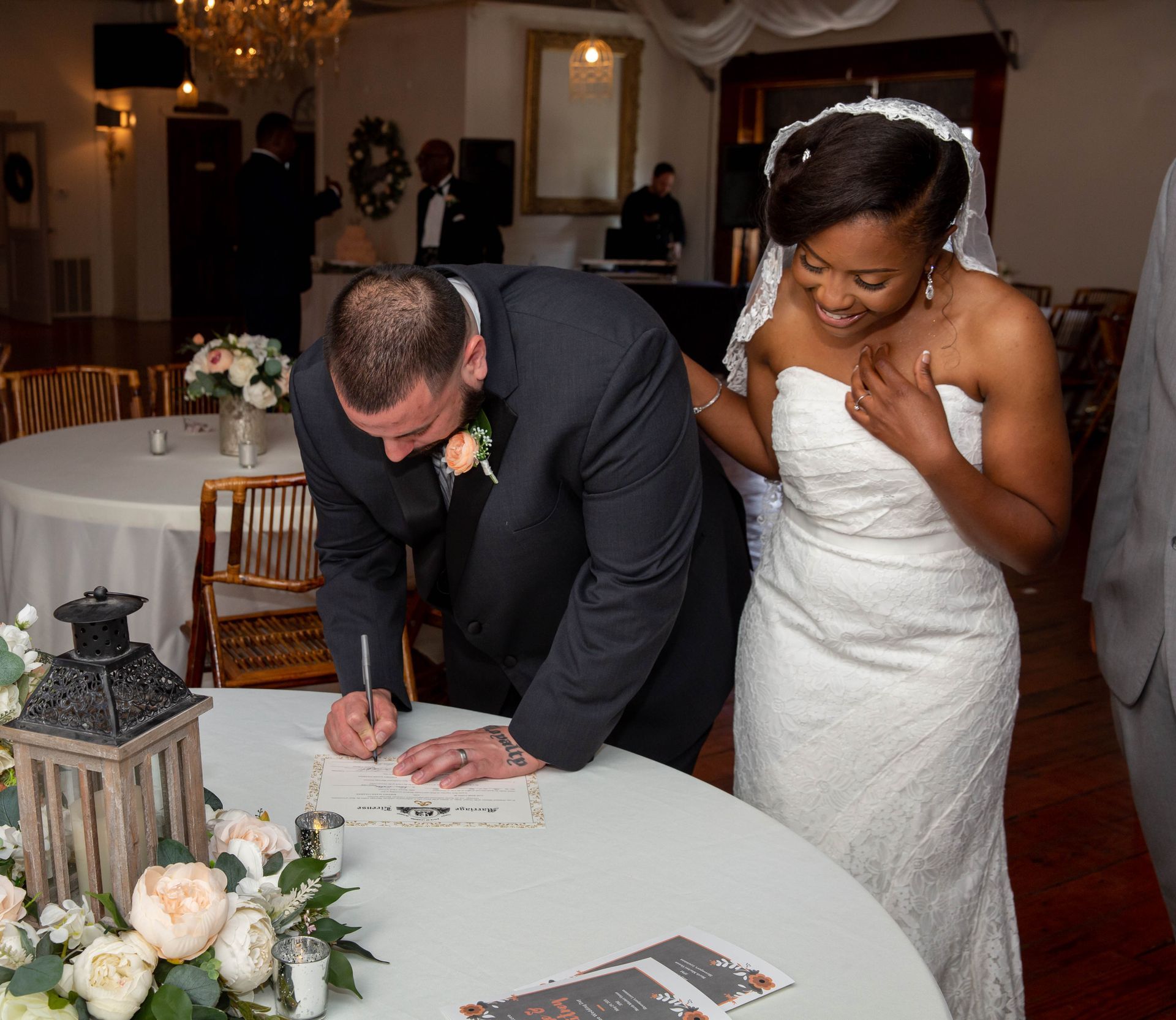 A bride and groom sign their wedding registry
