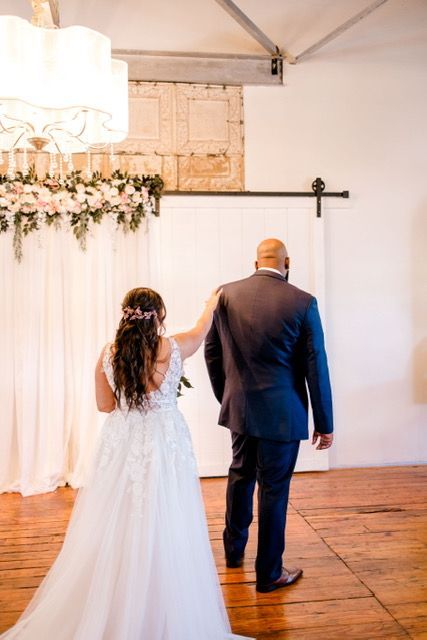 A bride and groom are walking down the aisle at their wedding.