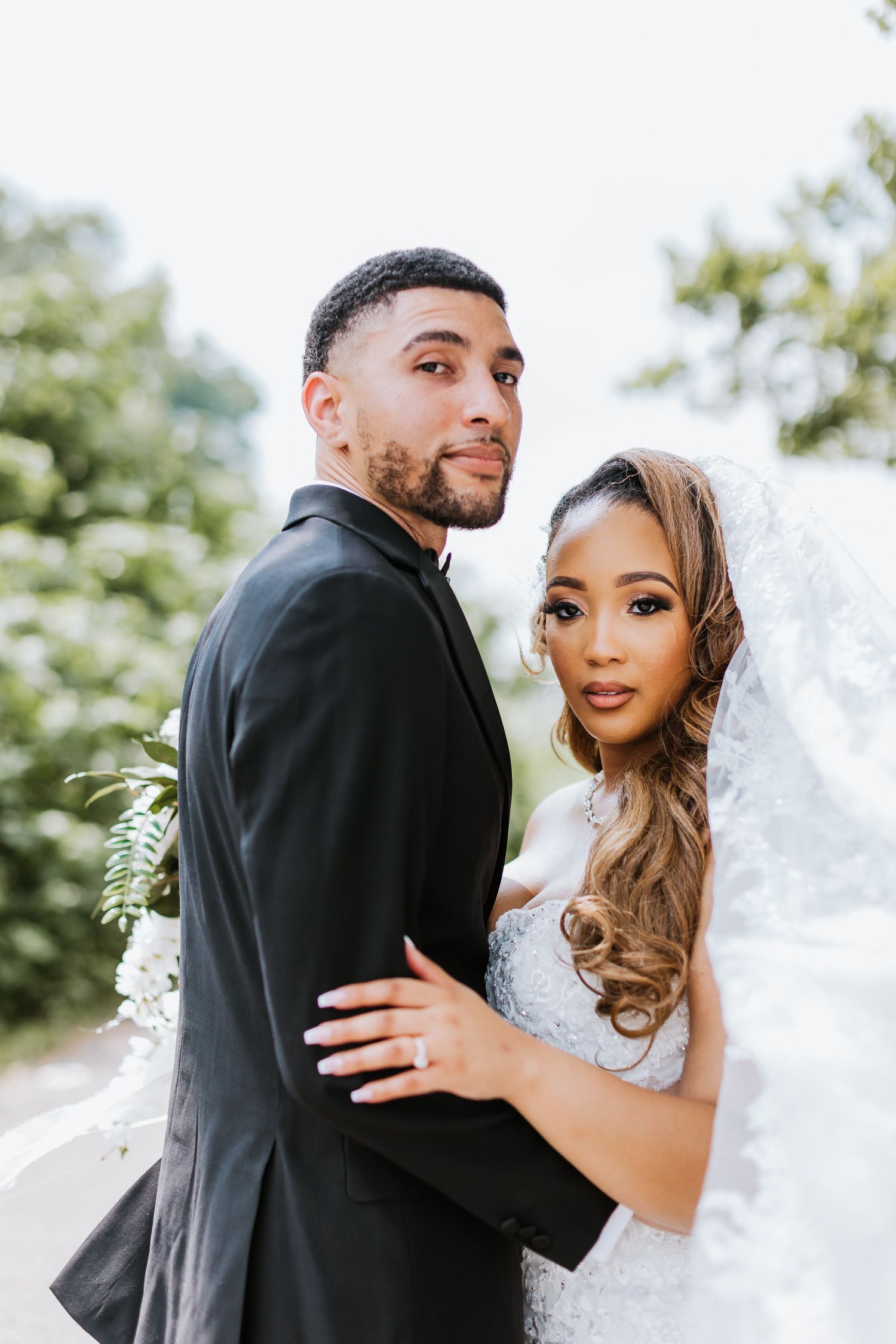 A bride and groom are posing for a picture on their wedding day.