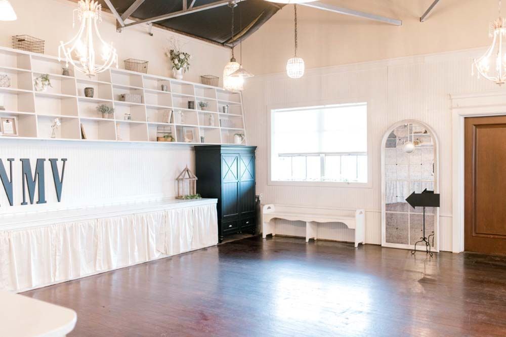 A large empty room with a lot of shelves and a mirror.