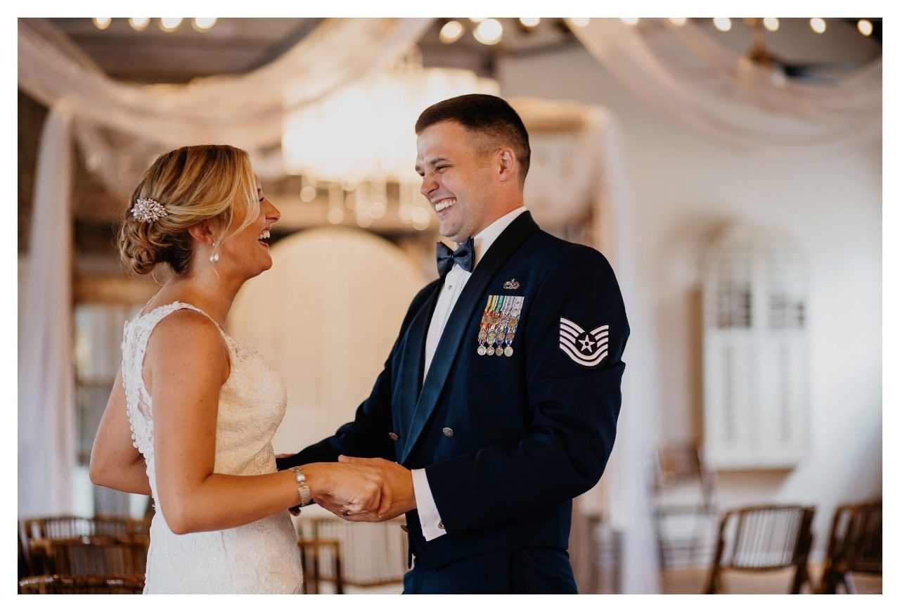 A bride and groom are dancing together at their wedding reception.